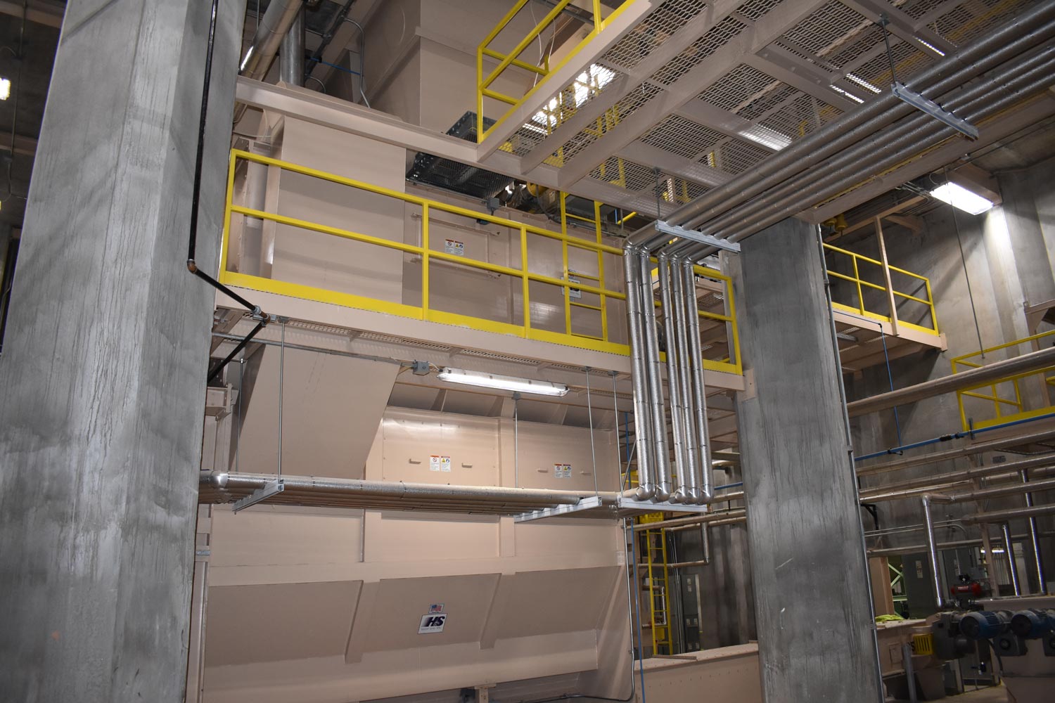 Industrial facility with metal pipes and platforms.