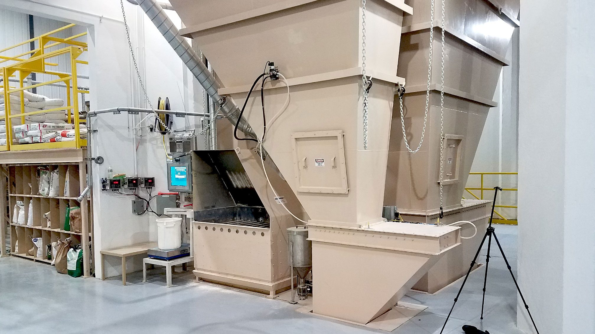 Factory machinery with storage hoppers