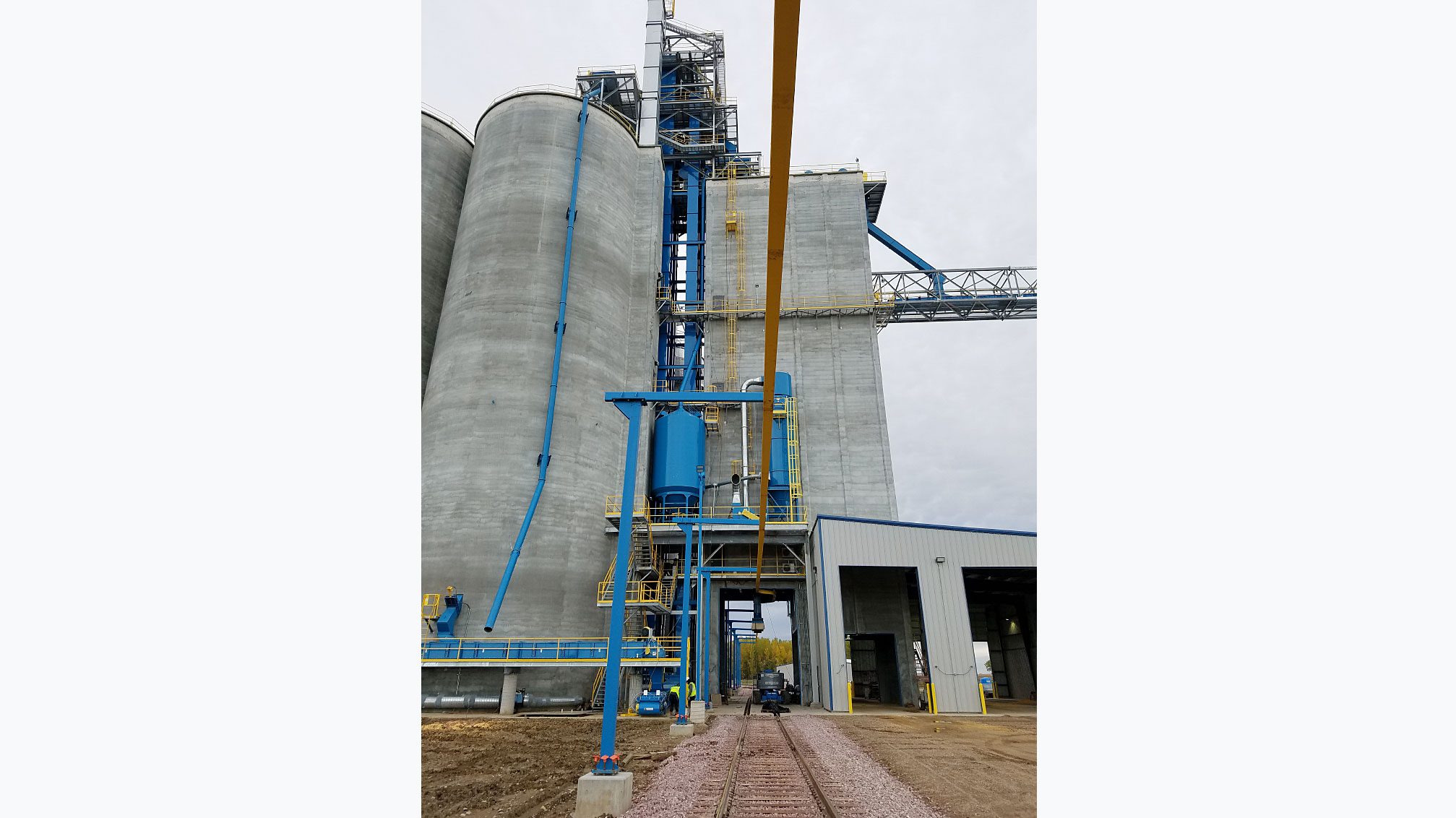 Industrial grain silos with blue piping
